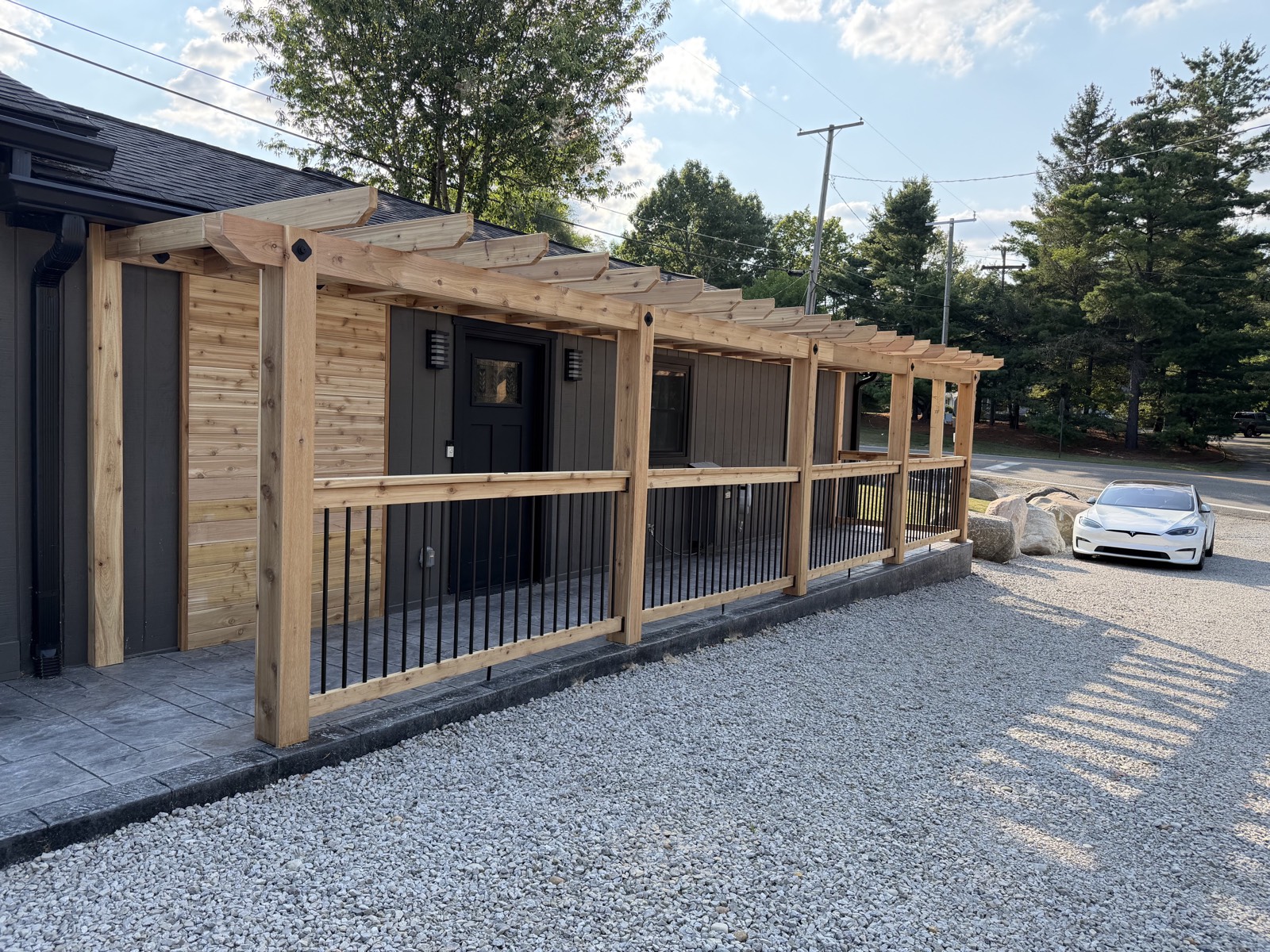 The Pergola — cedar pergola and railing along the back of the home